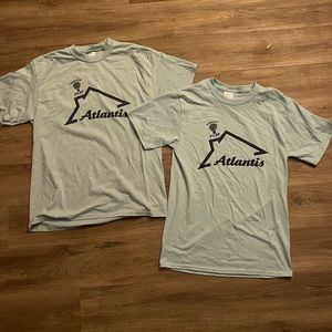 Two light blue Atlantis T-shirt’s